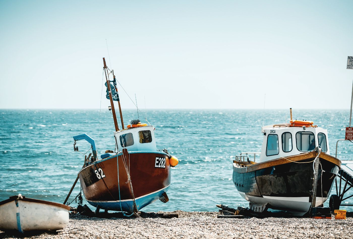 boats on beach in beer town in devon