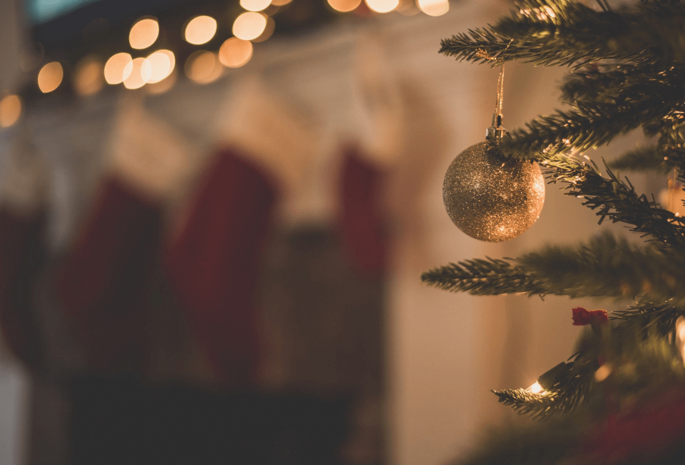 Christmas tree with stockings in background