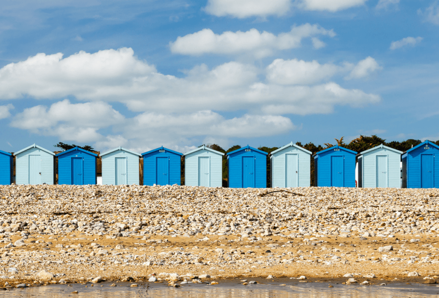 Row of beach huts on Charmouth Beach
