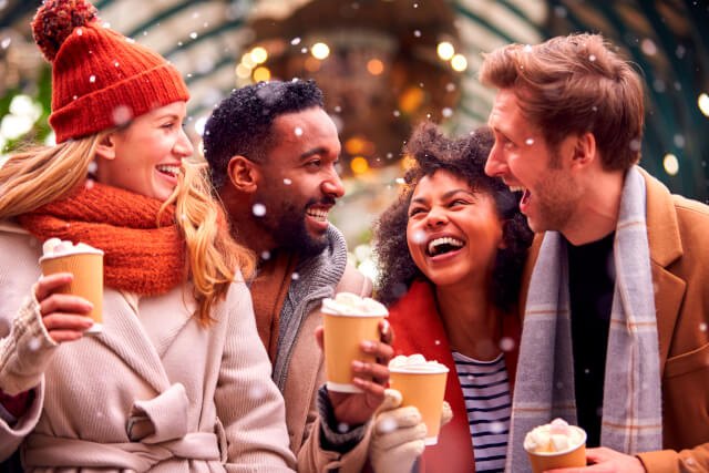 riends with hot chocolate at Christmas market