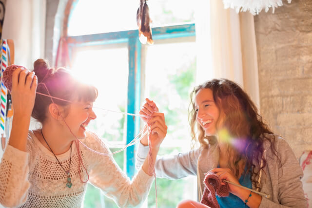 women playing with yarn