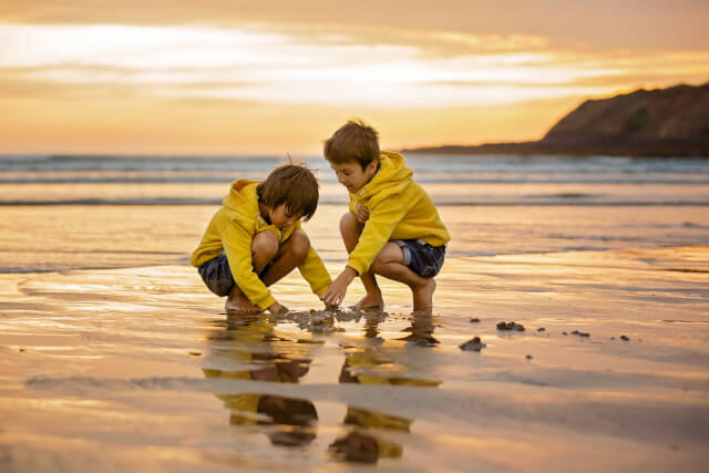Two boys playing on a beach