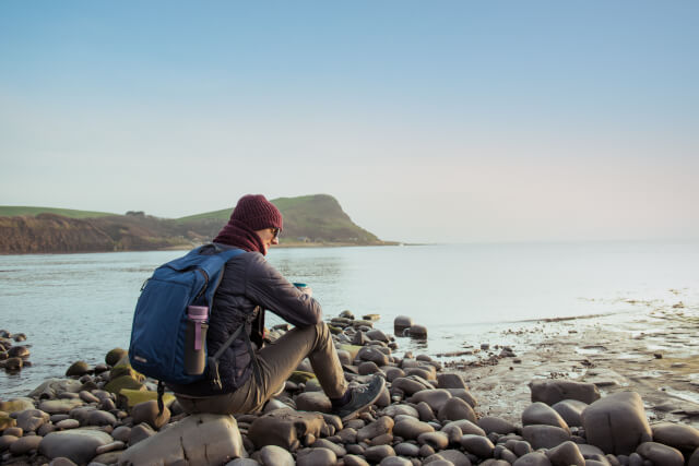 Young man drinking coffee at Jurassic Coast