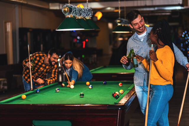 Friends playing pool at Charmouth dog-friendly pub