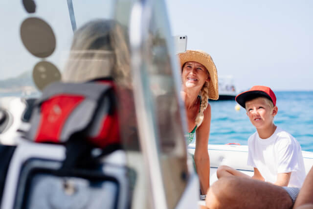 Mother and son taking selfie on boat