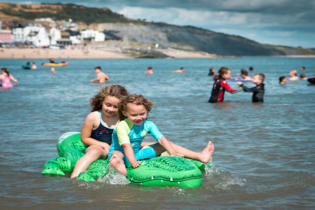 Young children in sea at Lyme Regis