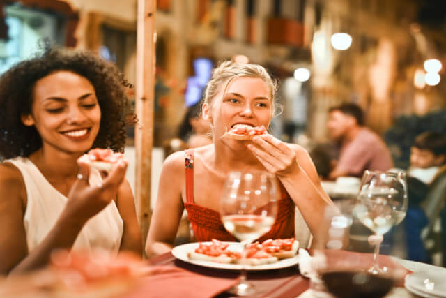 Two women tucking into pub food