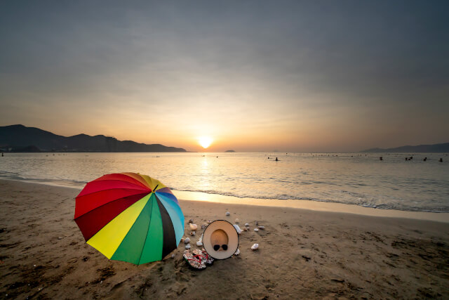 Sandy beach with summer accessories