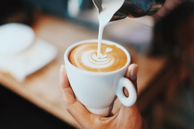 Barista pouring coffee